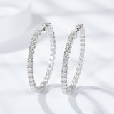 Close-up of moissanite stone setting on geometric circle earring