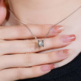 Side profile of layered double-chain necklace with round bead and textured strands