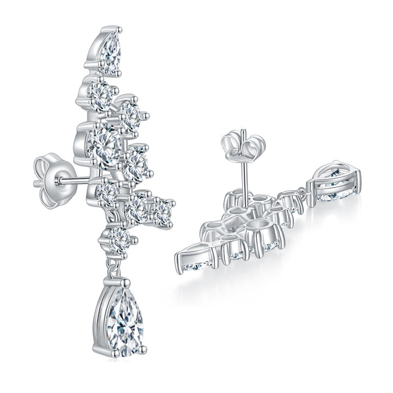 Lifestyle image of earrings worn on a model's ear with soft natural lighting and neutral backdrop
