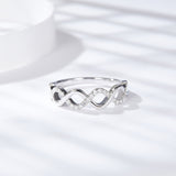 Side angle showing interwoven band structure and 0.2 carat oval moissanite stone