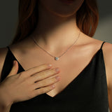 Close-up of round moissanite stone set in geometric sterling silver frame