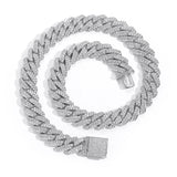 White gold Cuban chain necklace on marble surface with soft focus