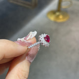 Detail shot of moissanite accent stones flanking the ruby on the sterling silver band