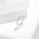 Close-up of three 5.0mm round moissanite stones with 3EX cut sparkle detail