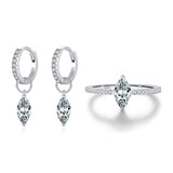 Top-down flat lay of ring and matching stud earrings arranged symmetrically