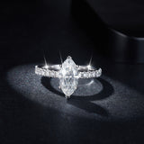 Close-up side profile showing 6mm x 12mm oval moissanite center stone and polished band