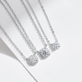 Side profile of round pendant moissanite necklace on model