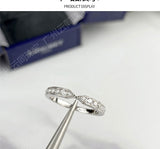 Rings arranged in heart shape on marble surface