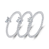 Top-down view of round moissanite ring highlighting symmetrical stone placement