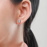 Close-up detail of prong-set simulated diamonds on geometric silver earring face