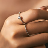 Close-up of round moissanite stone set in sterling silver solitaire ring