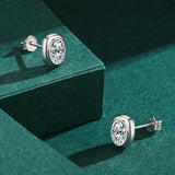 Square stud earrings styled on an earlobe with natural lighting and soft shadow