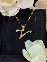 V letter pendant captured mid-motion to highlight chain flexibility and movement