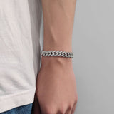 Bracelet stacked with two thinner chains for layered styling