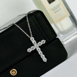 Side angle showing geometric diamond-shaped cross pendant and chain detail