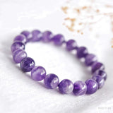 Close-up detail of smooth round amethyst beads showing natural lavender color variation