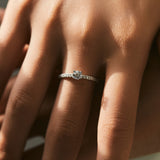 Close-up of round moissanite stones set in geometric pattern on sterling silver band