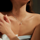 Close-up of oval moissanite stone set in geometric sterling silver frame