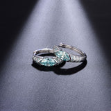 Side profile showing 4x8mm oval moissanite stones and gold-plated sterling silver setting