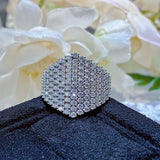 Close-up macro shot of 1.5mm pavé moissanite stones and brilliant 1.65-carat center stone under studio lighting