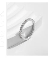 Ring shown on model's finger with natural lighting and soft focus background