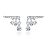 Sterling silver waterdrop earrings styled on a model's ear with soft natural lighting