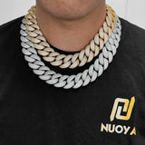 Lifestyle shot: gold Cuban chain necklace and bracelet worn with black t-shirt and denim jacket