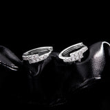 Lifestyle shot: hoops worn on model's ears with natural lighting and neutral backdrop