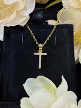 T letter pendant styled with open-collar shirt for professional yet personal look