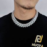 White gold 14mm Cuban chain on dark fabric background