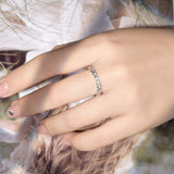 Close-up of round brilliant moissanite stones set in gold-plated silver with reflective sparkle