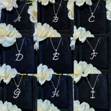 Necklace draped over folded linen for relaxed, tactile lifestyle aesthetic