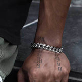 Bracelet laid diagonally across dark fabric for dramatic contrast and highlight