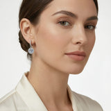 Elegant female model wearing petite moissanite halo drop earring — luxury editorial