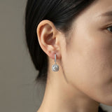 Woman wearing the S925 colorful moissanite halo hoop earring with hanging pendant
