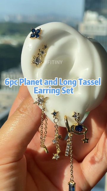 Gold Planet and Long Tassel Earrings on Display