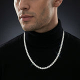Man wearing an iced out moissanite tennis chain necklace