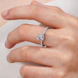 Woman wearing an emerald-cut moissanite engagement ring