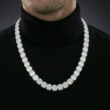Man wearing a 6.5mm iced out moissanite tennis chain necklace